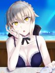  1girl arm_support artoria_pendragon_(all) artoria_pendragon_(swimsuit_rider_alter) bangs bare_shoulders bikini black_bow blue_bikini blue_sky blush bow braid breasts caruta cleavage collarbone commentary_request cup day drinking_glass eyebrows_visible_through_hair fate/grand_order fate_(series) fingernails frilled_bikini frills hair_between_eyes head_tilt highres horizon light_brown_hair looking_at_viewer medium_breasts ocean outdoors parted_lips sidelocks sky solo spill swimsuit water wine_glass yellow_eyes 