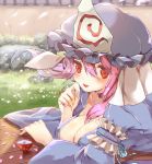  1girl arm_garter bangs between_breasts blue_dress blue_kimono blush breasts cherry_blossoms choker cleavage collarbone cup dress frills grass hand_on_own_cheek hat highres japanese_clothes kimono large_breasts long_sleeves looking_at_viewer lying mob_cap on_stomach open_mouth petals pink_hair red_eyes rock saigyouji_yuyuko smile solo touhou triangular_headpiece upper_body varyu wall wide_sleeves wind wind_lift 