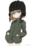  1girl bangs black_hat blonde_hair blue_eyes closed_mouth commentary emblem eyebrows_visible_through_hair frown girls_und_panzer green_jumpsuit hands_in_pockets hat helmet katyusha long_sleeves military military_uniform pravda_military_uniform shibagami short_hair short_jumpsuit solo tank_helmet twitter_username uniform v-shaped_eyebrows white_background 