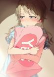 1girl bangs blue_shirt blush brown_eyes closed_mouth commentary_request eyebrows_visible_through_hair gomennasai idolmaster idolmaster_cinderella_girls indoors light_brown_hair long_hair looking_away looking_to_the_side morikubo_nono picture_frame pillow pillow_hug shirt short_sleeves solo wavy_mouth yes yes-no_pillow 