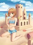  1girl antenna_hair barefoot beach bikini bikini_skirt blue_bikini blue_sky blurry brown_hair bucket card_captor_sakura clouds day depth_of_field flag frilled_bikini frills green_eyes kero kinomoto_sakura looking_at_viewer navel outdoors rin_cat sand_castle sand_sculpture short_hair shovel sky swimsuit worktool 