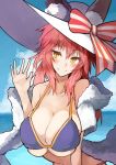  1girl animal_ears bikini blue_bikini blush breasts cleavage collarbone ears_through_headwear fate/grand_order fate_(series) fox_ears hat highres himuka_(523) large_breasts looking_at_viewer ocean outdoors pink_hair ribbon side-tie_bikini solo sun_hat swimsuit tamamo_(fate)_(all) tamamo_no_mae_(swimsuit_lancer)_(fate) yellow_eyes 