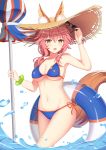  1girl animal_ears bikini blue_bikini breasts ears_through_headwear fate/grand_order fate_(series) fox_ears fox_tail hat highres holding holding_umbrella innertube large_breasts long_hair looking_at_viewer muq navel parasol pink_hair side-tie_bikini sky solo sun_hat sunglasses swimsuit tail tamamo_(fate)_(all) tamamo_no_mae_(swimsuit_lancer)_(fate) umbrella wading yellow_eyes 