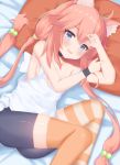  1girl absurdres animal_ears arms_up bike_shorts blue_eyes breasts cat_ears commentary_request fang hair_bobbles hair_ornament highres hinata_channel knees_up long_hair low_twintails lying mismatched_legwear nekomiya_hinata on_side open_mouth orange_legwear pillow pink_hair shorts small_breasts smile solo striped striped_legwear thigh-highs twintails vest white_vest wristband 