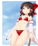  1girl bare_shoulders bikini black_hair blue_sky border bow brown_eyes clouds collarbone commentary_request cowboy_shot day detached_sleeves eyebrows_visible_through_hair frilled_bow frills groin hair_between_eyes hair_bow hair_tubes hakurei_reimu highres long_hair long_sleeves miyo_(ranthath) navel outdoors outside_border red_bikini red_bow ribbon-trimmed_sleeves ribbon_trim side-tie_bikini sky solo standing stomach swimsuit thighs touhou white_border wide_sleeves 