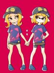  2girls baseball_cap clothes_writing comamawa hand_holding hand_on_hip hat highres inkling looking_at_another matching_outfit multiple_girls octoling orange_eyes orange_hair pink_background pointy_ears short_hair short_shorts shorts shorts_under_skirt smile splatoon splatoon_2 standing tentacle_hair 