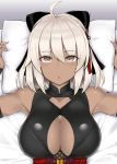  1girl ahoge arms_up bangs bare_shoulders black_bow bow breasts cleavage cleavage_cutout commentary_request dark_skin eyebrows_visible_through_hair eyes_visible_through_hair fate/grand_order fate_(series) hair_bow large_breasts looking_at_viewer lying mitsukazu_(nijigen_complex) okita_souji_(alter)_(fate) okita_souji_(fate)_(all) on_back on_bed open_mouth pillow pillow_grab sleeveless solo upper_body white_hair white_pillow yellow_eyes 