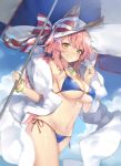  1girl animal_ears bangs bare_shoulders bikini blue_bikini blue_sky blush bracelet breasts cleavage closed_mouth clouds cowboy_shot eyebrows_visible_through_hair fate/grand_order fate_(series) fox_ears hair_between_eyes hat highres jewelry kikistark large_breasts long_hair looking_at_viewer navel necklace ocean outdoors pendant pink_hair ribbon shiny shiny_skin side-tie_bikini sky smile solo standing stomach striped striped_ribbon sun_hat swimsuit tamamo_(fate)_(all) tamamo_no_mae_(fate) tamamo_no_mae_(swimsuit_lancer)_(fate) umbrella under_boob yellow_eyes 
