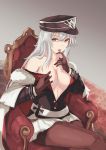  1girl absurdres azur_lane breasts cleavage finger_licking gloves graf_zeppelin_(azur_lane) hand_in_hair hand_on_breast hat highres licking long_hair looking_at_viewer military military_hat military_uniform open_clothes pantyhose red_eyes silver_hair simple_background sitting solo tsyn uniform 