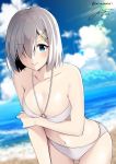  1girl beach bikini blue_eyes blue_sky blurry breasts cleavage clouds collarbone commentary_request cowboy_shot dated depth_of_field eyebrows_visible_through_hair hair_ornament hair_over_one_eye hairclip hamakaze_(kantai_collection) kantai_collection large_breasts leaning_forward lens_flare light_rays lips looking_at_viewer mimamui navel outdoors short_hair signature silver_hair sky solo sunbeam sunlight swimsuit twitter_username white_bikini 