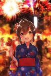  1girl :d aerial_fireworks bangs blue_kimono blurry blurry_background blush brown_eyes brown_hair candy_apple commentary_request depth_of_field eyebrows_visible_through_hair fireworks flower food hair_between_eyes hair_bun hair_flower hair_ornament head_tilt holding holding_food ichihaya japanese_clothes kimono long_sleeves obi open_mouth original print_kimono red_flower sash smile solo_focus standing wide_sleeves 