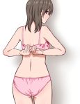  1girl adjusting_bra adjusting_clothes ass back bra brown_eyes brown_hair floral_print from_behind highres looking_back original panties pink_bra pink_panties solo standing tuskryo underwear 