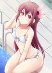  1girl adjusting_hair bangs bare_shoulders between_legs bikini blush closed_mouth crescent crescent_moon_pin day hair_between_eyes hair_ornament hand_between_legs highres kantai_collection kisaragi_(kantai_collection) long_hair looking_at_viewer minakami_mimimi navel outdoors partially_submerged pool poolside purple_hair remodel_(kantai_collection) sidelocks sitting smile solo stomach swimsuit violet_eyes white_bikini 
