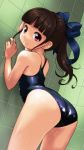  1girl against_wall ass bare_arms bare_shoulders bent_over blue_bow blue_swimsuit blush bow brown_hair commentary_request dutch_angle hair_bow indoors leaning_forward long_hair looking_at_viewer looking_back one-piece_swimsuit original ponytail rohitsuka school_swimsuit solo swimsuit tile_wall tiles violet_eyes 