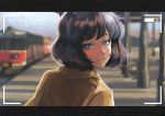  1girl blue_eyes brown_shirt closed_mouth commentary english_commentary ground_vehicle looking_at_viewer original outdoors shirt short_hair solo sunlight train train_station upper_body 