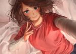  1girl absurdres bed_sheet blue_eyes blush brown_hair character_name closed_mouth faiz_azhar highres long_sleeves looking_at_viewer lying on_back on_bed original red_shirt self_shot shirt short_over_long_sleeves short_sleeves smile solo upper_body 