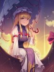  1girl absurdres blonde_hair bow breasts brown_eyes eyebrows_visible_through_hair hat highres holding holding_umbrella large_breasts long_hair long_sleeves looking_at_viewer mob_cap parted_lips red_bow sitting smile solo teeth touhou umbrella wnehdrl yakumo_yukari 