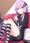  1girl :o bangs blush couch cup eyebrows_visible_through_hair grey_shorts hair_between_eyes hair_ornament highres holding holding_cup hood hoodie horizontal_stripes indoors knees_together_feet_apart long_hair long_sleeves low_twintails nintendo_switch open_mouth pillow purple_hair shorts sitting socks solo striped striped_legwear twintails violet_eyes vocaloid voiceroid yukarite yuzuki_yukari 