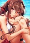  1girl artist_name beach bikini blush breasts brown_hair cleavage closed_mouth collarbone day flower hair_between_eyes hair_flower hair_intakes hair_ornament hand_on_own_knee highres kantai_collection knees_up large_breasts lips long_hair looking_at_viewer nail_polish red_nails sakiyamama sarong sidelocks smile solo swimsuit thigh_strap very_long_hair violet_eyes white_bikini yamato_(kantai_collection) 