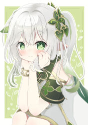  1girl absurdres bare_shoulders bloomers blush border bracelet cape closed_mouth cross-shaped_pupils dress genshin_impact grabbing_own_hair green_background green_cape green_eyes green_hair green_sleeves hair_between_eyes hair_ornament hands_on_own_cheeks hands_on_own_face highres jewelry leaf_hair_ornament looking_at_viewer multicolored_hair nahida_(genshin_impact) pointy_ears side_ponytail sitting sleeveless symbol-shaped_pupils upper_body white_border white_dress white_hair 