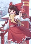  1girl absurdres armpits blush bow brown_eyes brown_hair day detached_sleeves eyebrows_visible_through_hair goback hair_bow hair_tubes hakurei_reimu highres holding long_hair looking_at_viewer navel open_mouth outdoors railing red_bow smile snow snowing solo torii touhou tree winter 