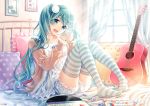  1girl :d acoustic_guitar aqua_eyes aqua_hair bed candy cup food guitar hatsune_miku hima_(ab_gata) holding holding_cup instrument long_hair long_sleeves looking_at_viewer open_mouth picture_(object) picture_frame record sheet_music sitting smile striped striped_legwear thigh-highs twintails vocaloid zettai_ryouiki 