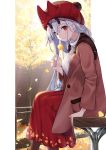  1girl autumn autumn_leaves bangs beanie bench breasts brown_jacket commentary_request day fate/grand_order fate_(series) feet_out_of_frame ginkgo ginkgo_leaf hair_between_eyes hat highres holding holding_leaf horned_headwear horns jacket leaf leaf_print long_hair long_sleeves looking_at_viewer medium_breasts oni oni_horns outdoors pantyhose pom_pom_(clothes) red_eyes red_skirt silver_hair sitting skirt smile solo takubon_(xewh4773) tomoe_gozen_(fate/grand_order) tree 