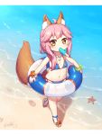  1girl animal_ear_fluff animal_ears bangs bare_shoulders beach bikini blue_bikini blush bracelet brown_footwear brown_hair commentary_request day eyebrows_visible_through_hair fate/grand_order fate_(series) flat_chest food food_in_mouth fox_ears fox_girl fox_tail highres holding holding_innertube innertube jewelry langbazi letterboxed long_hair looking_at_viewer mouth_hold navel necklace outdoors pink_hair popsicle revision sand sandals side-tie_bikini sidelocks signature solo standing standing_on_one_leg starfish swimsuit tail tail_raised tamamo_(fate)_(all) tamamo_no_mae_(swimsuit_lancer)_(fate) water younger 