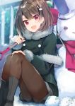  1girl :d ameshizuku_natsuki bangs black_footwear blush boots brown_hair brown_legwear bucket bucket_hat bunny_hair_ornament capelet commentary_request day eyebrows_visible_through_hair fur-trimmed_capelet fur-trimmed_jacket fur-trimmed_sleeves fur_trim green_capelet green_jacket grey_shorts hair_between_eyes hair_ornament hand_on_own_knee hat head_tilt holding holding_shovel jacket long_sleeves looking_at_viewer open_mouth original outdoors pantyhose railing red_eyes short_shorts shorts shovel sitting smile snow snow_bunny snowman solo 