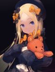  1girl abigail_williams_(fate/grand_order) bangs black_bow black_dress black_hat blonde_hair blue_eyes bow closed_mouth commentary_request dress fate/grand_order fate_(series) forehead hair_bow hat head_tilt long_hair long_sleeves looking_at_viewer object_hug orange_bow parted_bangs polka_dot polka_dot_bow roll_okashi sleeves_past_fingers sleeves_past_wrists solo stuffed_animal stuffed_toy teddy_bear upper_body very_long_hair 