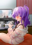  1girl alcohol animal_hood bangs bare_legs bare_shoulders beer beer_can blurry blurry_background blush breasts camisole can cleavage commentary_request curtains depth_of_field food hair_ornament hair_scrunchie highres holding holding_can hood hoodie indoors kumagai_ayato long_hair long_sleeves looking_at_viewer mouth_hold original pocky ponytail purple_hair scrunchie sitting striped table television violet_eyes wooden_floor 