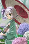  1girl alternate_costume bangs blue_flower blunt_bangs blurry closed_mouth commentary_request depth_of_field flower from_side green_eyes green_kimono hair_ribbon highres holding holding_umbrella hydrangea japanese_clothes kimono konpaku_youmu light_smile long_sleeves looking_at_viewer nunupon0514 obi oriental_umbrella outdoors pink_flower purple_ribbon ribbon sash short_hair solo touhou umbrella white_flower white_hair wide_sleeves 