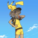  1girl ayumi_(pokemon) backpack bag bangs baseball_cap blue_sky blush brown_eyes brown_hair clouds commentary_request creatures_(company) day eyebrows_visible_through_hair game_freak gen_1_pokemon grin hand_on_hip hand_up hat highres holding holding_poke_ball nintendo on_head outdoors pikachu poke_ball poke_ball_(generic) pokemon pokemon_(creature) pokemon_(game) pokemon_lgpe shirt short_shorts shorts sky smile standing tugo yellow_hat yellow_shirt yellow_shorts 