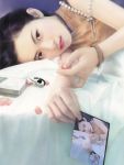  black_hair chen_shu_fen digital_media_player earphones highres ipod petals photo_(object) picture realistic 
