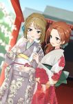  2girls arm_up blue_sky blurry brown_eyes commentary_request cowboy_shot day depth_of_field dutch_angle floral_print flower green_eyes hair_flower hair_ornament hair_up holding holding_paper idolmaster idolmaster_cinderella_girls japanese_clothes kawashima_mizuki kimono light_brown_hair long_sleeves looking_at_viewer looking_to_the_side mole multiple_girls obi omikuji open_mouth outdoors paper ponytail redhead sash sky standing takagaki_kaede torii wide_sleeves zerorou_(himitunoko2) 