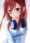  1girl :t blue_eyes blue_shirt blurry blurry_background blush brown_hair closed_mouth collarbone commentary_request depth_of_field eyes_visible_through_hair go-toubun_no_hanayome headphones headphones_around_neck highres long_hair long_sleeves looking_away looking_to_the_side nakano_miku pout shirt solo upper_body yano_mitsuki 