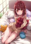  1girl ahoge alt arm_support atelier_(series) atelier_sophie bangs bare_legs bare_shoulders bedroom blush braid brown_eyes brown_hair closed_mouth collarbone commentary_request dress eyebrows_visible_through_hair full_body hair_ornament highres holding holding_pillow indoors looking_at_viewer medium_hair off-shoulder_sweater on_bed pillow ribbed_sweater side_braid sitting sleeves_past_wrists smile solo sophie_neuenmuller star_pillow sweater sweater_dress window yellow_sweater 