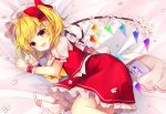  1girl :d ascot bangs bed_sheet blonde_hair blush bow cherry_blossoms commentary crystal eyebrows_visible_through_hair fang feet_out_of_frame flandre_scarlet hands_up hat hat_bow highres looking_at_viewer lying mob_cap on_side one_side_up open_mouth petals petticoat puffy_short_sleeves puffy_sleeves red_bow red_eyes red_skirt red_vest ruhika shirt short_hair short_sleeves skirt skirt_set smile solo symbol_commentary touhou vest white_hat white_shirt wings wrist_cuffs yellow_neckwear 