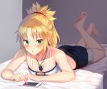  1girl :o absurdres barefoot bed bed_sheet black_shorts blonde_hair blush breasts cellphone cleavage collarbone commentary_request eyebrows_visible_through_hair fate/apocrypha fate_(series) green_eyes highres jewelry jun_(540000000000000) looking_at_viewer lying midriff mordred_(fate) mordred_(fate)_(all) on_bed on_stomach pendant phone ponytail short_hair shorts small_breasts solo 