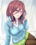  1girl bangs black_legwear blue_cardigan blue_eyes blush breasts brown_hair cardigan go-toubun_no_hanayome green_skirt hair_between_eyes hand_on_headphones headphones headphones_around_neck heckler_kai highres large_breasts long_sleeves looking_at_viewer medium_hair nakano_miku open_mouth pantyhose shirt sitting skirt solo white_shirt 