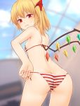  1girl ass bangs bare_arms bare_shoulders bikini blonde_hair blurry blurry_background blush butt_crack commentary_request cowboy_shot crystal eyebrows_visible_through_hair flandre_scarlet from_behind hair_between_eyes hair_ribbon highres indoors looking_back miyo_(ranthath) no_hat no_headwear one_side_up red_bikini red_eyes red_ribbon ribbon short_hair solo standing striped striped_bikini sweat swimsuit thighs touhou white_bikini wings 