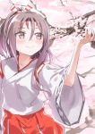  1girl brown_eyes cherry_blossoms closed_mouth commentary_request cowboy_shot flower gedoo_(gedo) hachimaki hair_between_eyes hakama headband high_ponytail highres japanese_clothes kantai_collection light_brown_hair long_hair ponytail red_hakama smile solo zuihou_(kantai_collection) 