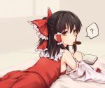  1girl ? ass bare_shoulders bed black_hair book bow breasts commentary_request cowboy_shot detached_sleeves food_in_mouth frilled_bow frilled_shirt_collar frills from_behind grey_background hair_bow hair_tubes hakurei_reimu half_updo long_hair long_sleeves looking_at_viewer looking_back lying medium_breasts miyo_(ranthath) mouth_hold on_stomach red_bow red_eyes red_ribbon red_skirt ribbon ribbon-trimmed_sleeves ribbon_trim shadow sideboob sidelocks simple_background skirt skirt_set solo spoken_question_mark touhou wide_sleeves 