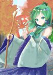  1girl autumn autumn_leaves bare_shoulders blue_skirt blue_sky closed_mouth collared_shirt commentary_request detached_sleeves dutch_angle eyebrows_visible_through_hair frog_hair_ornament green_eyes green_hair hair_ornament hair_tubes highres holding holding_leaf holding_stick kochiya_sanae leaf long_hair long_skirt looking_at_viewer shelk787 shiny shiny_hair shirt skirt sky sleeveless sleeveless_shirt sleeves_past_wrists smile snake_hair_ornament solo stick torii touhou white_shirt 