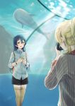  2girls aquarium ayase_eli bangs blonde_hair blue_hair blush camera commentary_request eyebrows_visible_through_hair fish_tank flower hair_between_eyes highres holding holding_camera holding_flower long_hair long_sleeves looking_at_another love_live! love_live!_school_idol_festival love_live!_school_idol_project multiple_girls open_mouth shorts smile solo_focus sonoda_umi standing suito taking_picture thigh-highs water yellow_eyes 