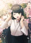  1girl alternate_costume bangs bell black_hair blurry blurry_background blush chabashira_tenko cherry_blossoms choker commentary dangan_ronpa eyebrows_visible_through_hair flower green_eyes hair_flower hair_ornament hair_ribbon hairband hand_in_hair holding long_hair mole mole_under_mouth new_dangan_ronpa_v3 one_eye_closed open_mouth outdoors ribbon smile solo ssumbi white_flower 