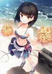  1girl absurdres bangs bare_shoulders bikini_top black_hair blush breasts brown_eyes cheerleader collarbone dual_wielding eyebrows_visible_through_hair full_body hair_ornament highres holding looking_at_viewer medium_breasts midriff navel open_mouth pom_poms scan senji_(tegone_spike) shiny shiny_hair shoes shore short_hair skirt smile sneakers socks solo standing stomach water white_legwear 