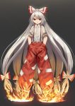  1girl dark_background fire fujiwara_no_mokou full_body grey_hair hair_ribbon hands_in_pockets highres long_hair looking_at_viewer ponytail red_eyes ribbon smile solo suna_(s73d) suspenders torn_clothes torn_sleeves touhou very_long_hair white_hair 