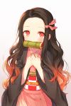  1girl black_hair blush eyebrows_visible_through_hair gradient gradient_background hair_ribbon hands_on_own_chest highres kamado_nezuko kh_(kh_1128) kimetsu_no_yaiba long_hair looking_at_viewer mouth_hold multicolored_hair pink_ribbon red_eyes redhead ribbon simple_background solo two-tone_hair upper_body very_long_hair 