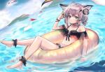  1girl ahoge animal_ears ankle_cuffs arknights bikini bird black_bikini blue_eyes blush brown_hair commentary dutch_angle fox_ears full_body headphones innertube looking_at_viewer outdoors seagull shipi_(qlenf0715) short_hair short_twintails sitting solo sussurro_(arknights) swimsuit twintails water wet 